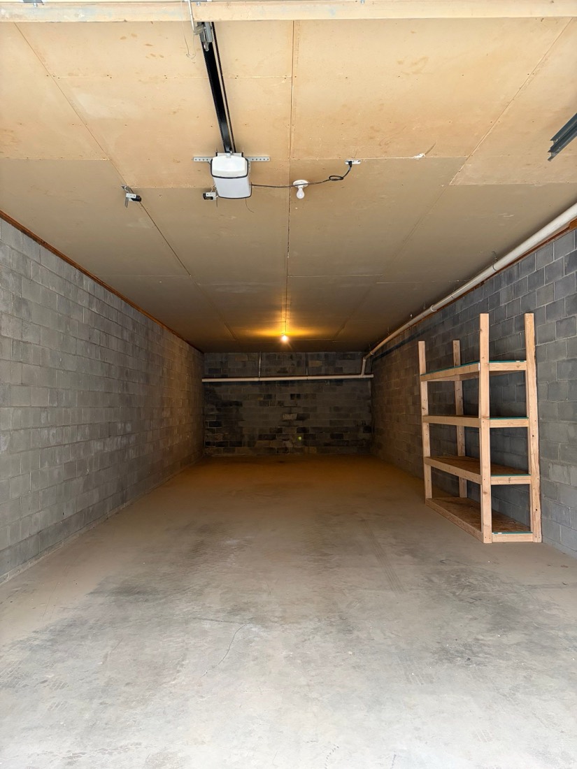 Interior of a storage bay at Oliver Square showing automatic door opener and LED lighting