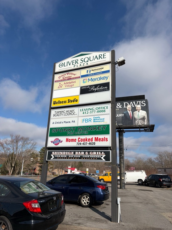 Oliver Square Plaza sign on Oliver Road in Uniontown, PA showing tenant directory